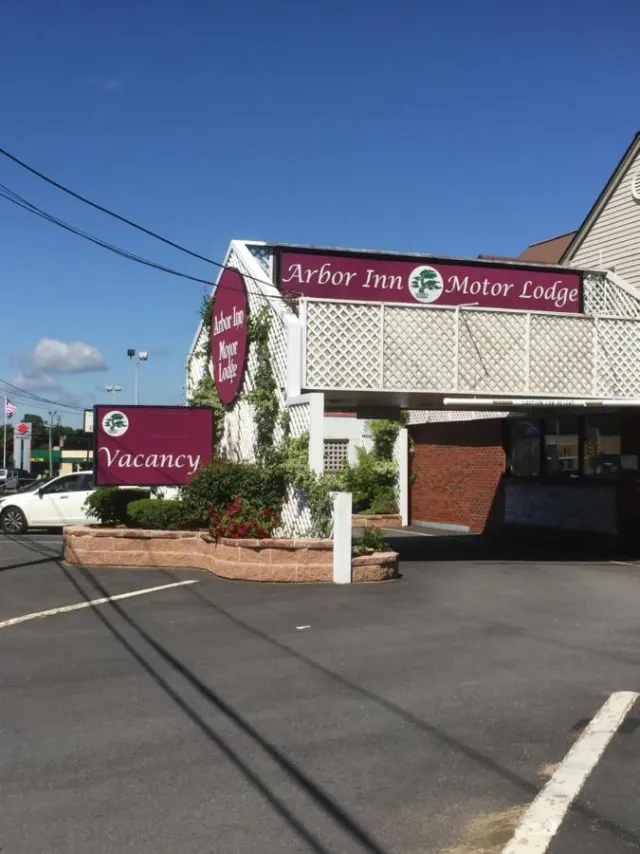 The Arbor Inn Motor Lodge roadside sign and front entrance on Bridge Street