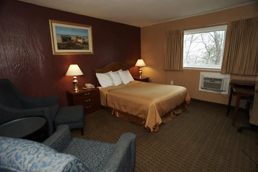 Guest room with bed, armchairs and window